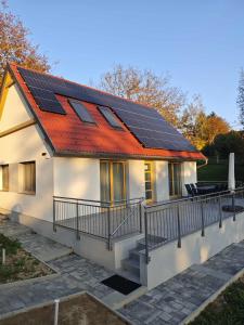 a house with solar panels on the roof at Dióliget Apartman in Orfű