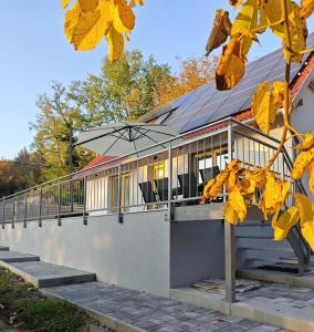 a building with an umbrella on the side of it at Dióliget Apartman in Orfű