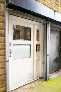 a white garage door with a window on a building at Firdaus Central Huddersfield Apartments in Huddersfield