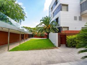 an exterior view of a building with a lawn at Sky Mirror in Baħar iċ-Ċagħaq