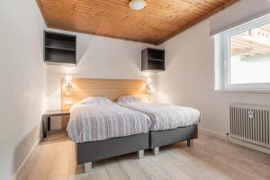 En eller flere senge i et værelse på Haus Dienten TOP 4