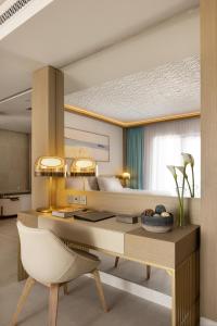 a bedroom with a desk and a bed at Jumeirah Gulf of Bahrain in Manama