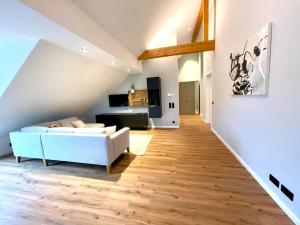 a living room with a white couch and wooden floors at Smart Living Worms in Worms