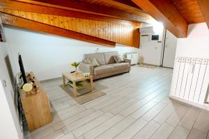 a living room with a couch and a table at Annagaia Home in Bellizzi