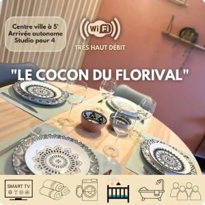a table with plates and wine glasses on it at Le cocon du Florival- Guebwiller in Guebwiller