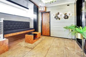 a lobby with a bench and a table and a door at Super Collection O KEYS ELITE in Vijayawada