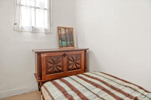 a bedroom with a wooden bed with a picture on it at Appartement 3eme étage in Castellane