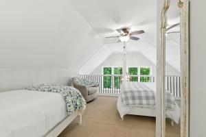 a bedroom with a bed and a ceiling fan at The Holiday House w Dock in Townville