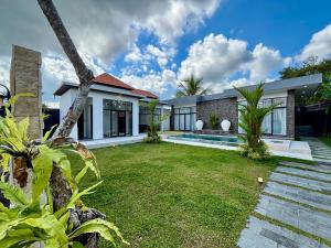 a house with a lawn in front of it at Palazzo Carangsari - 2-Bedroom Villa with Private Pool in Payangan +38 photos