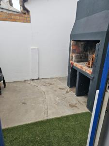 a fireplace in a garage with a fire place at Pik & Pikkie Self catering apartments in Lambertʼs Bay
