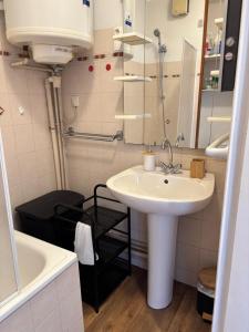a bathroom with a sink and a tub and a mirror at Le cocon du Canigou in Font-Romeu +15 photos