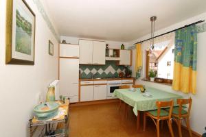 a kitchen and dining room with a table and chairs at Limerhof in Waischenfeld