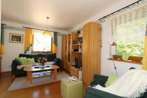a living room with a couch and a table at Limerhof in Waischenfeld