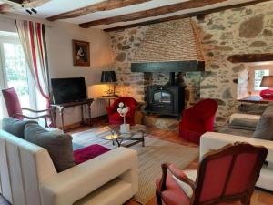 a living room with a couch and a fireplace at Le moulin in Nexon