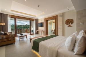 a bedroom with a large bed and a balcony at Sanggraloka Ubud in Ubud