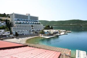 a large hotel on the shore of a body of water at Seaside Apartman Neum in Neum