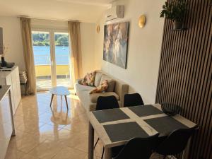 a living room with a couch and a table at Medulin - Romeo - Wohnung direkt am Meer in Medulin