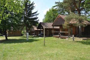 a group of cottages in a yard with trees at Camping du Haut-Koenigsbourg - Onlycamp in Lièpvre +3 photos