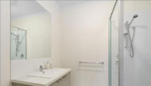 a white bathroom with a sink and a shower at Goodlett Corner- oasis of peace in Loch Sport +24 photos