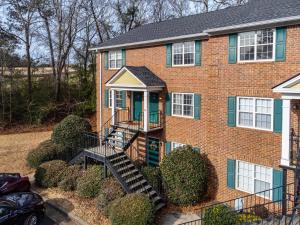 a brick house with a staircase leading to the front door at Woodstone Retreat right next to UGA golf course in Athens
