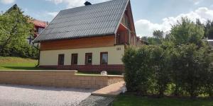 a house with a metal roof on top of it at Chata Wellness Březka in Libuň