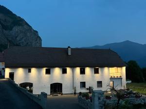 a large white building with a dark roof at Les Serres d'Antan in Le Glaizil