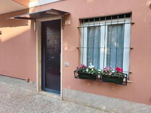 a building with a window with flower boxes on it at Casa Nanni in Genova