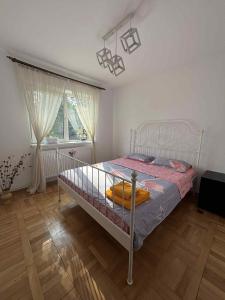 a bedroom with a bed with a surfboard on it at Wine Road Apartment in Gura Vadului