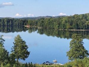 a view of a lake with a car parked on the shore at 4 person holiday home in GRÄNNA-By Traum in Gränna
