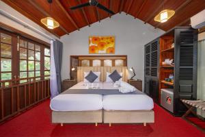 a bedroom with a large bed with two stuffed animals on it at Hoianbang Beach Front Villa and Restaurant in An Bang +61 photos
