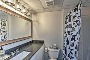 a bathroom with a sink and a toilet and a mirror at New Listing Blue Haven Nest w Dock in Martin +26 photos