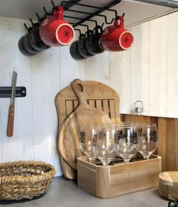 a group of wine glasses on a table with lights at La Tiny Des Bruyères 