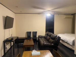 a living room with a couch and a bed at Kami no Tsuki - Vacation STAY 15816 in Akiruno