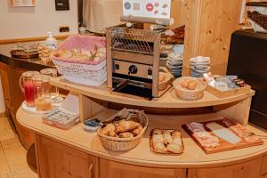 a bakery with a counter filled with bread and pastries at Garni Eden in Canazei