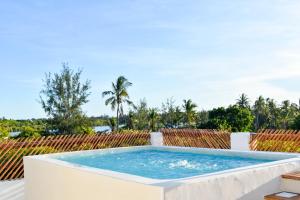 a plunge pool on the roof of a house at Mangrove Sunset Villa in Watamu