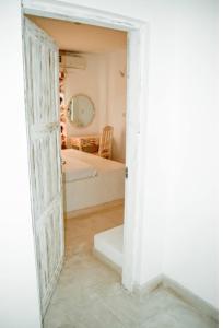an open door to a bedroom with a bed at Mangrove Sunset Villa in Watamu