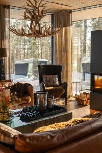 a living room with a leather couch and a chandelier at Levi OloResort in Levi +61 photos
