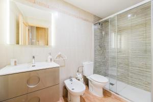 a bathroom with a toilet and a sink and a shower at Casa Las 4 Estaciones in Caudiel