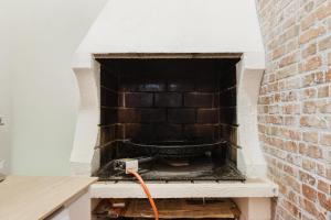 a brick oven with an orange cord plugged into it at Casa Las 4 Estaciones in Caudiel