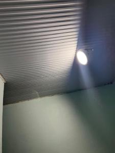 a white ceiling with a light in a room at Blue Zone in Kigali +1 photo