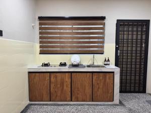 a kitchen with a sink and a window at Runa Homestay Jasin - Cozy 3BR with AC & Netflix in Jasin