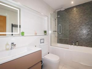 a bathroom with a toilet and a sink and a shower at Seaspell Beach House in Padstow +37 photos