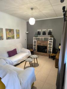 a living room with two couches and a fireplace at Vivienda en Liétor "La Manchega" in Liétor