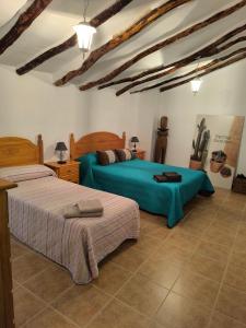 a bedroom with two beds in a room at Vivienda en Liétor "La Manchega" in Liétor