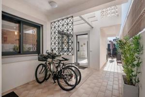 two bikes are parked in the front of a house at Villa - Canas Da Ria - Piscine in Santa Luzia