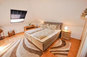 a bedroom with a large bed and a rug at Ferienwohnung KonradAlbrecht in Torgelow am See