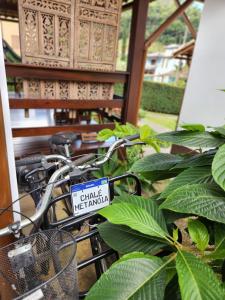 a bike with a sign on it parked next to a plant at Chalés Metanóia in São Pedro da Serra +27 photos