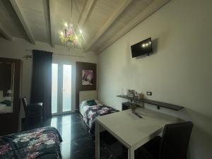 a room with a bed and a table in a room at Garda Relais Luna Blu in Peschiera del Garda