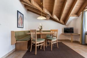 a dining room with a table and chairs at Soliva Hotel & Apartments by MEIN SAMNAUN - MOUNTAIN HOMES in Samnaun