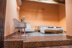 a room with a bed and a table and a chair at Casa Castanea in Trecastagni Catania in Trecastagni +15 photos
